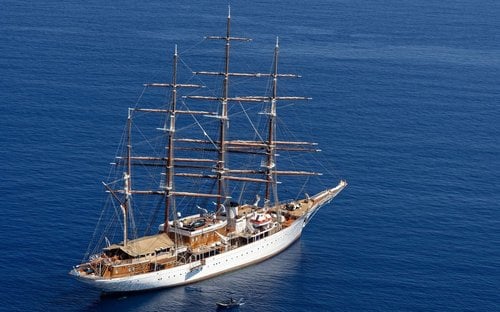 Windstar Cruises elegant masted sailing yacht in turquoise waters