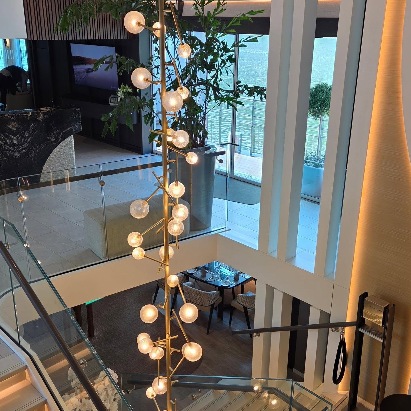 Cascading multi-deck glass globe chandelier in the central atrium of Amadeus Nova