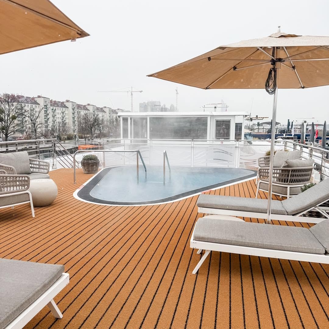 Heated swimming pool and cushioned sun loungers on the Sun Deck of Amadeus Nova