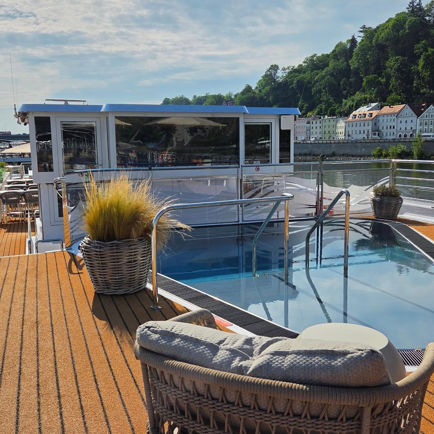 Sun Deck pool daybed and glass wheelhouse with Austrian hillside along the Danube aboard Amadeus Nova