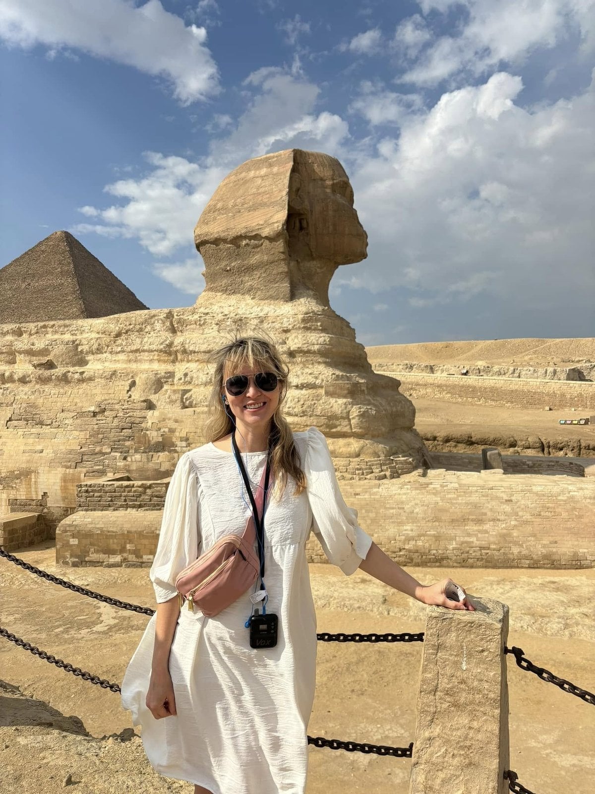 Amanda Burch standing in front of the Great Sphinx of Giza and the Pyramids on her Globus Egypt guided tour
