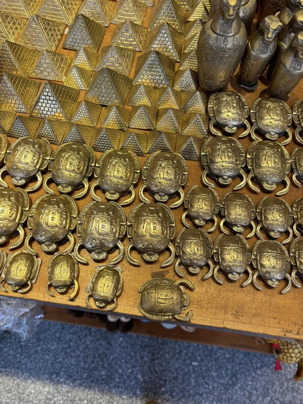 Traditional brass pyramids and intricate scarab beetles on display in Cairo