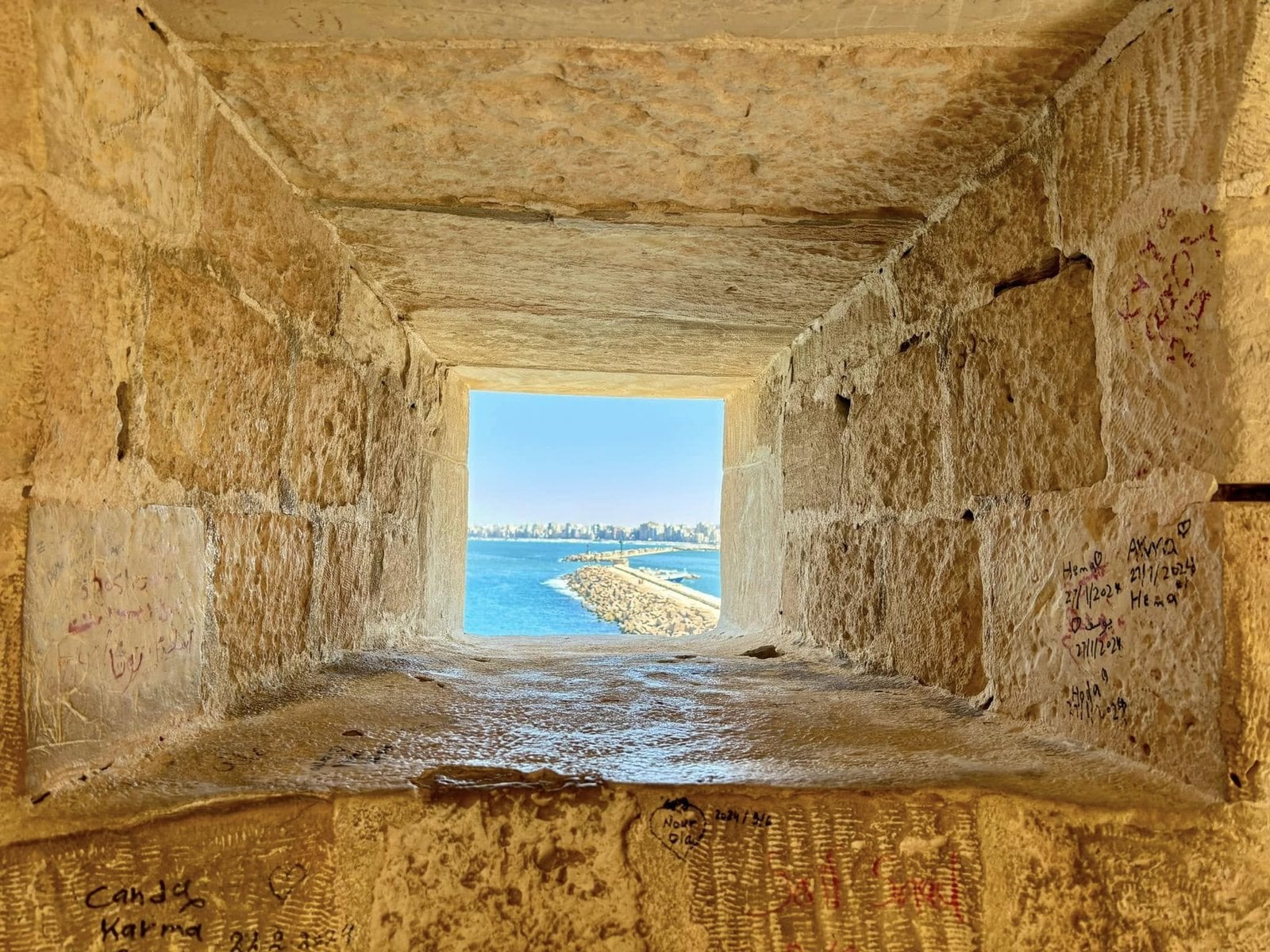 Turquoise Mediterranean waters framed by the ancient stone walls of Qaitbay Citadel in Alexandria