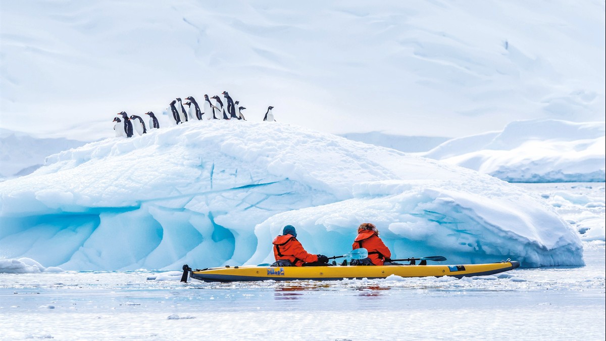 The National Geographic Sea Bird expedition ship sailing past a glacier in Alaska