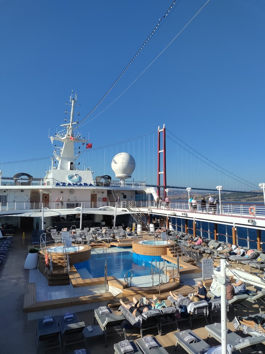 Resort style swimming pool and teak loungers on the sun deck of Azamara Onward