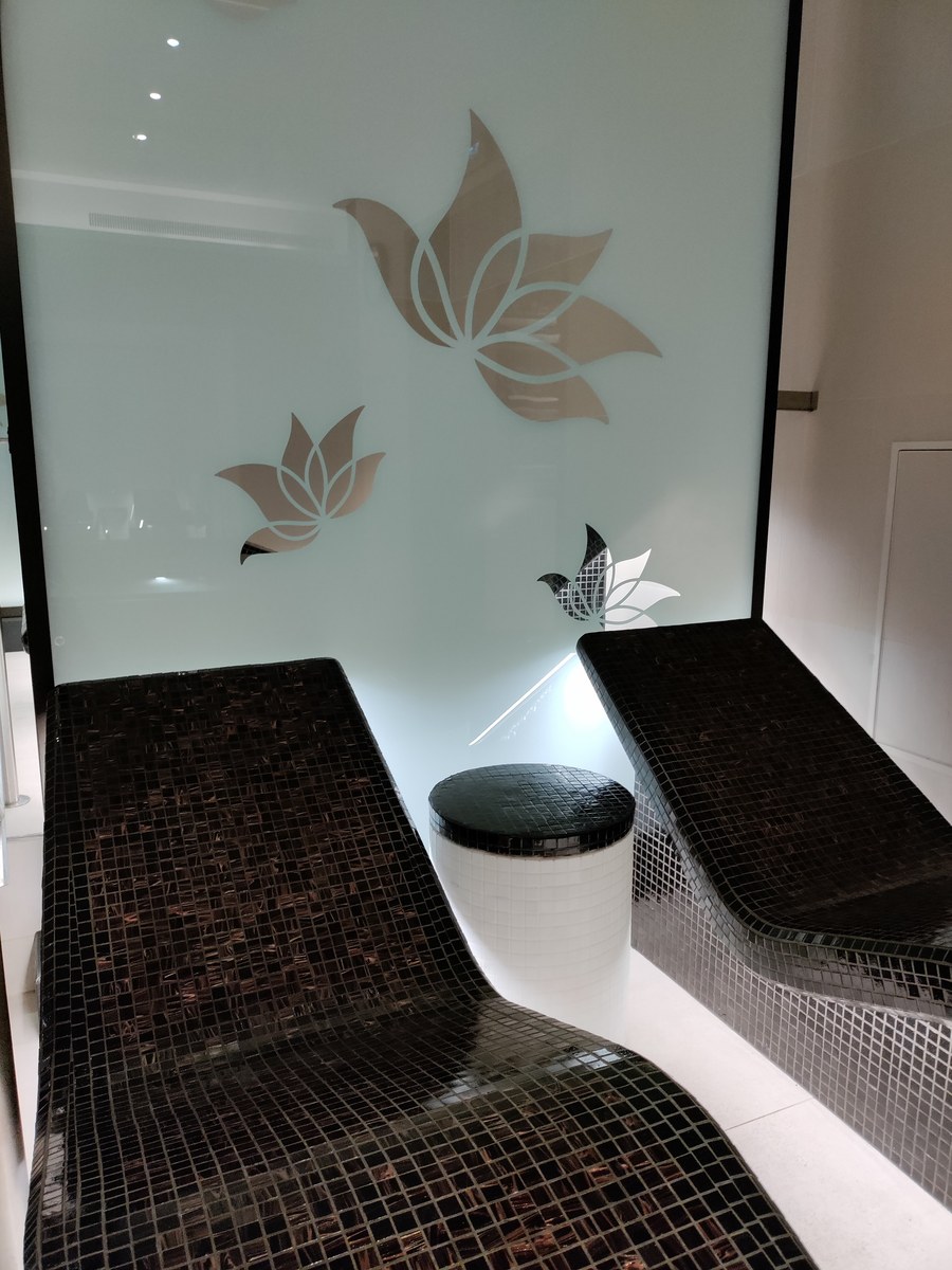 Heated ceramic stone loungers in The Enclave thermal suite