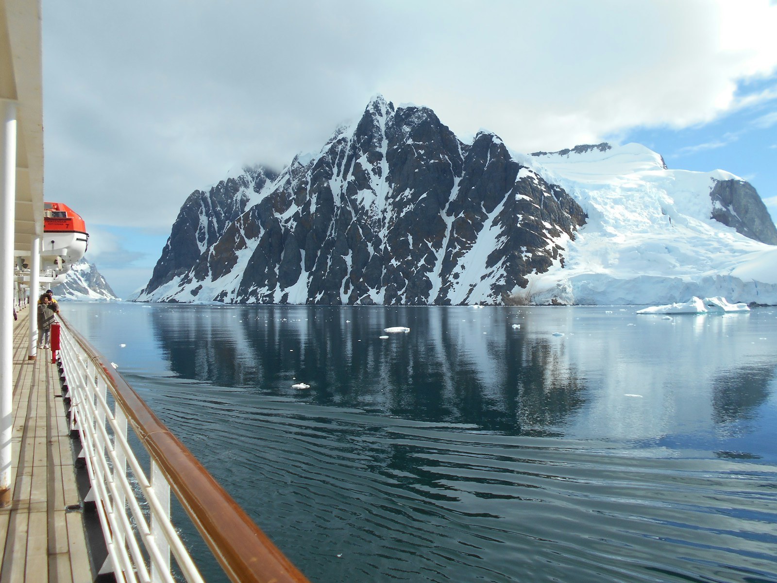Silversea luxury expedition ship sailing in Antarctic alpine fjord