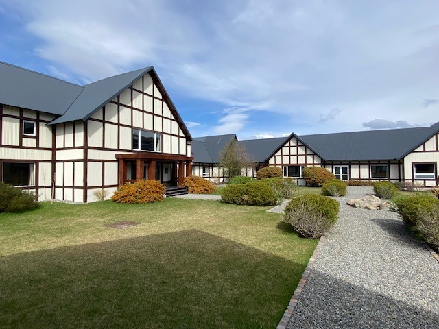 Exterior view of EOLO Patagonias Spirit lodge nestled in the sweeping golden steppe