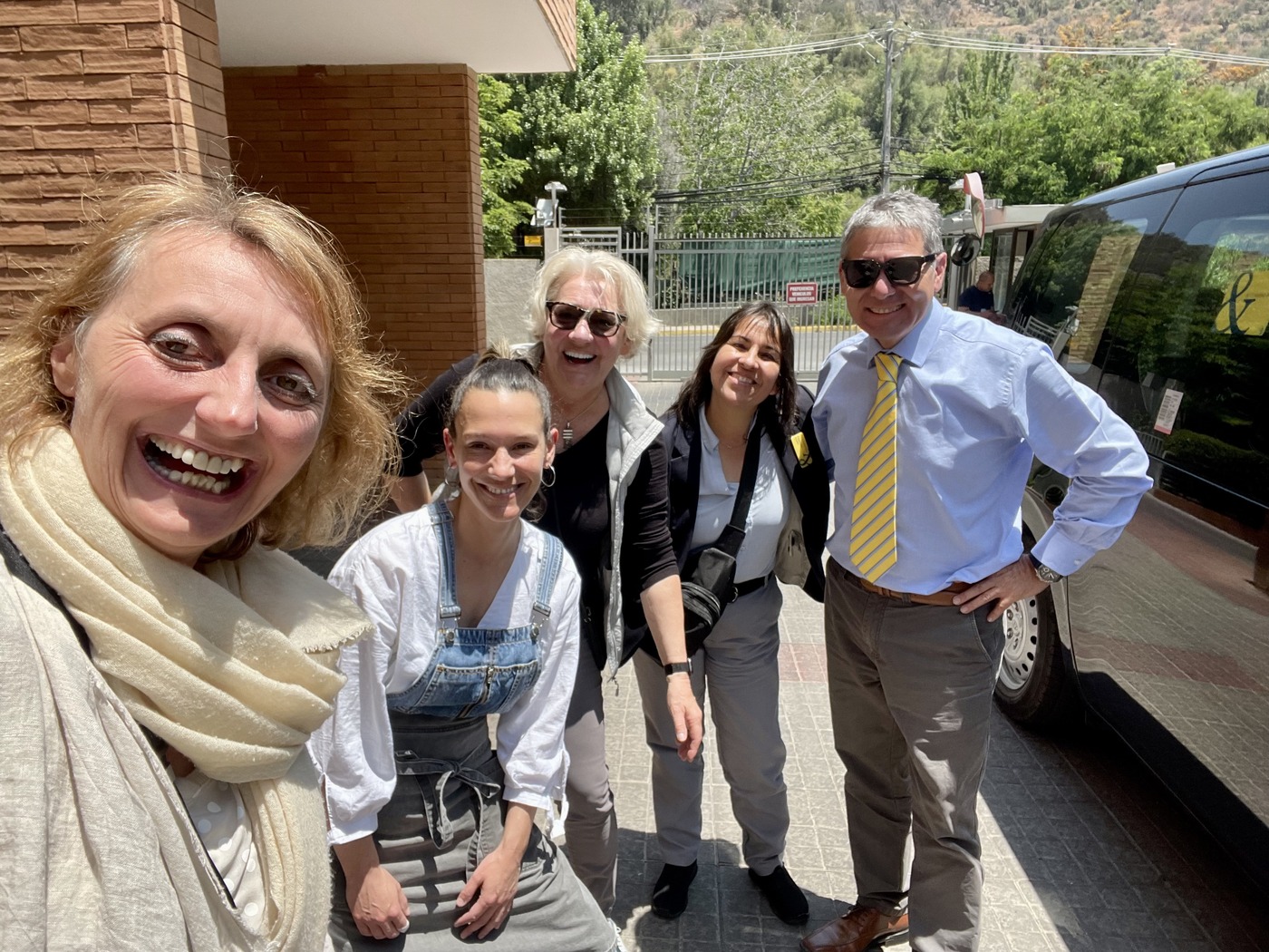 Group photo outside with Abercrombie & Kent private Mercedes van, driver, guide, chef, and Heidi