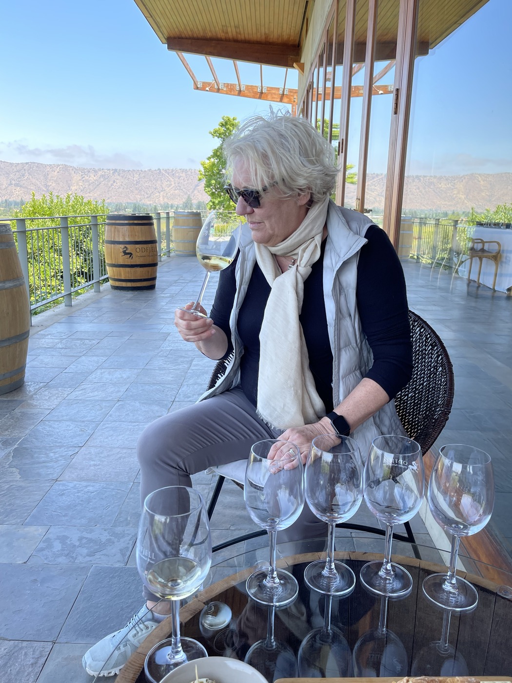 Heidi tasting white wine on the sunny terrace of Odfjell Vineyards