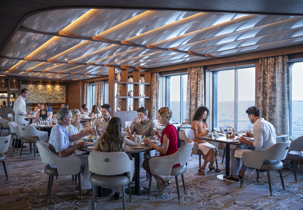 Celebrity Flora Seaside Restaurant dining room with floor-to-ceiling windows