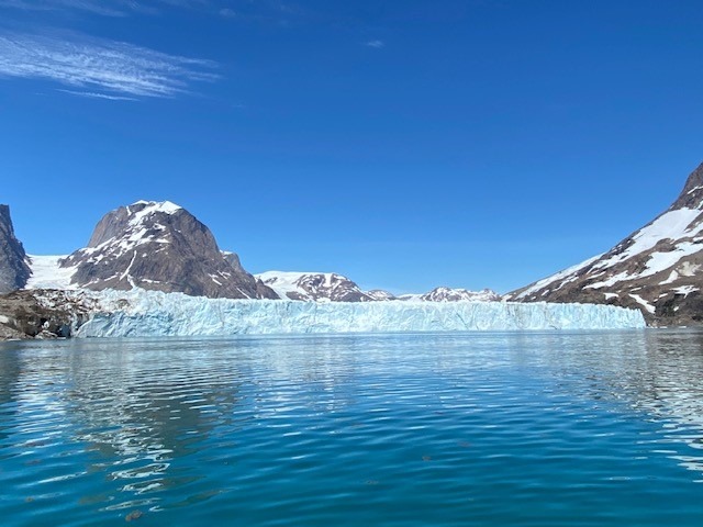 Massive tidewater glacier calving into Arctic sea in Greenland