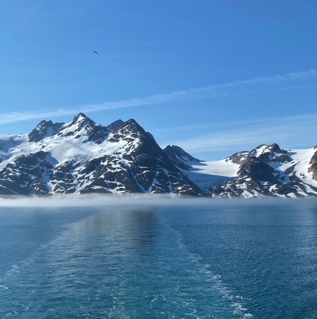 Spectacular Greenland fjord landscape with calm water and mountain reflections