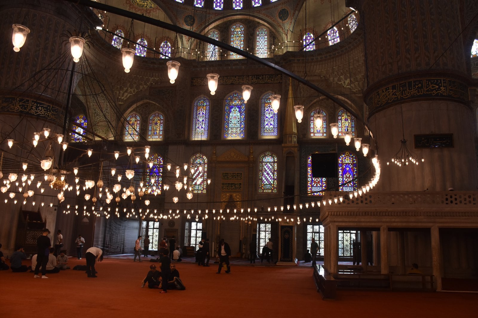 Intricate dome painting and blue ceramic tilework inside the Blue Mosque