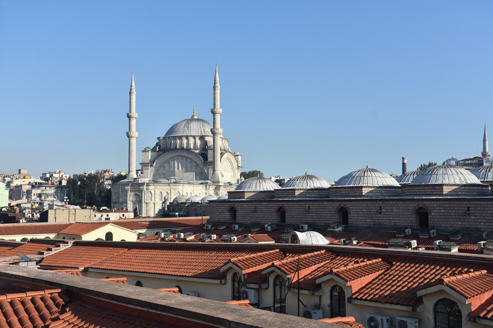 Iconic minarets and cascading domes of the Blue Mosque against a bright Istanbul sky