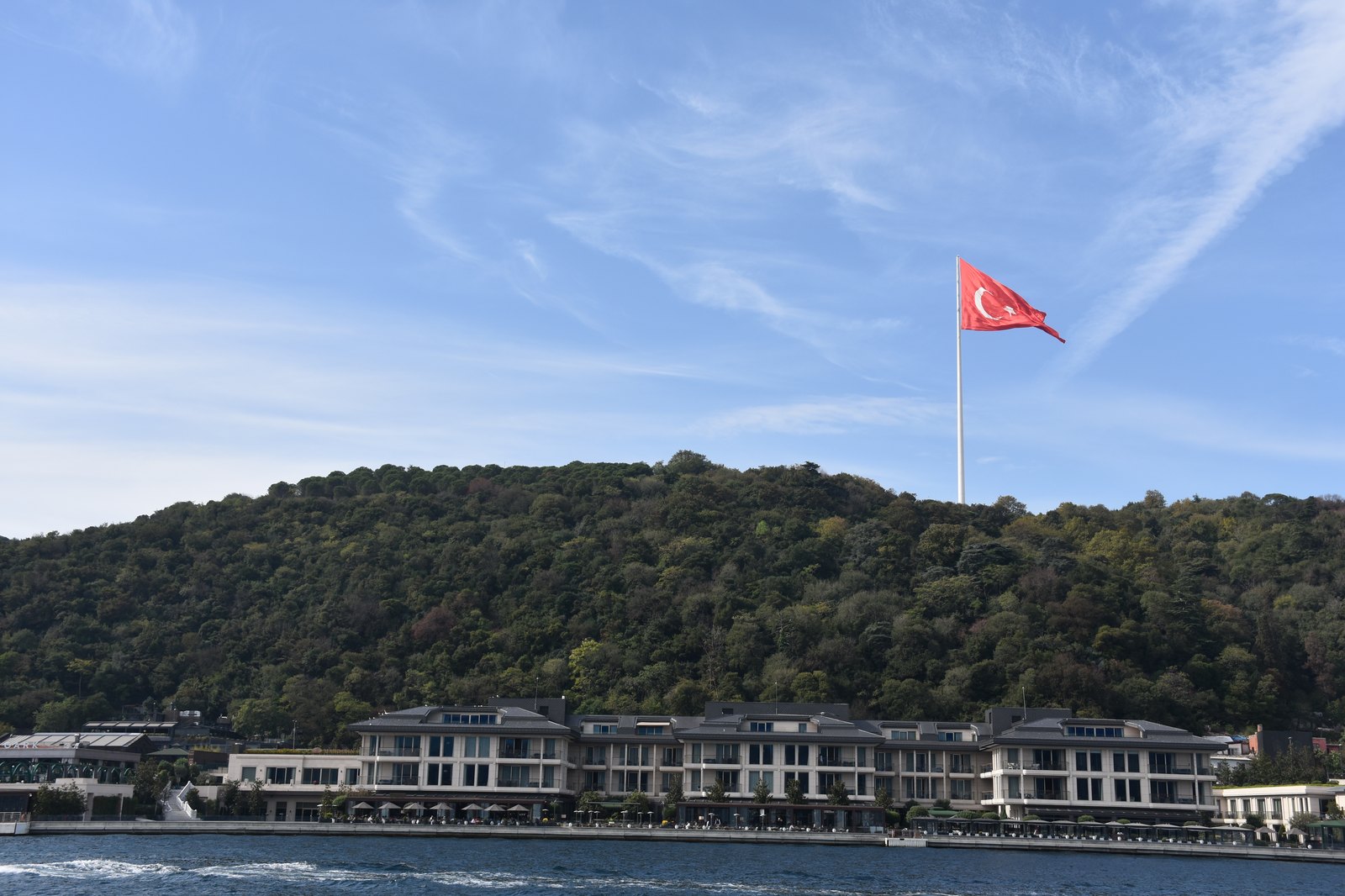Bosphorus waterway with historic waterfront mansions, wooden yalis, and European shoreline