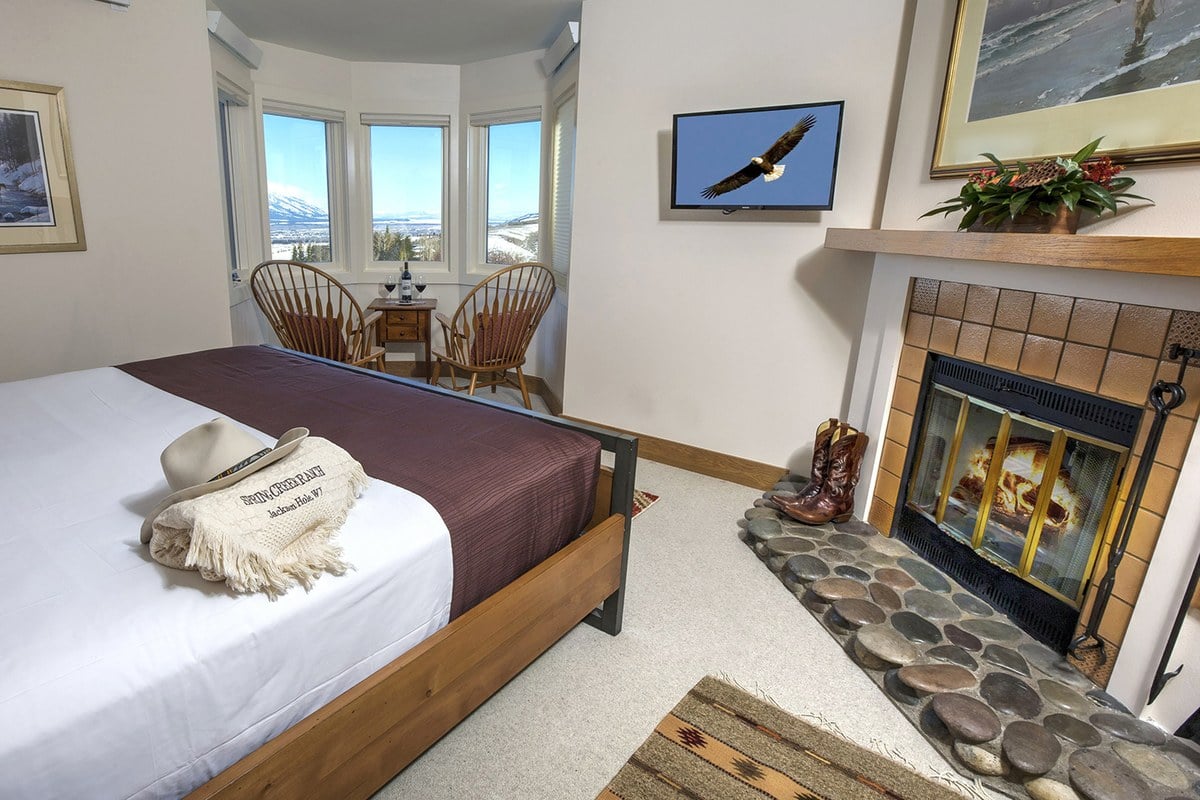 Spring Creek Ranch guest room with wood-burning fireplace