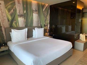 Elegantly appointed luxury bedroom suite at Savoy Palace in Madeira featuring custom headboard art and king bed