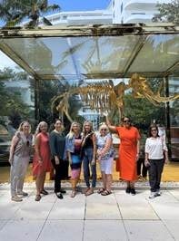 Travel advisors gathered at the famous Damien Hirst golden mammoth sculpture at Faena Miami Beach