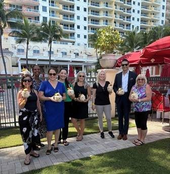Travel advisors enjoying an oceanfront welcome reception at Acqualina Resort on the Beach in Miami