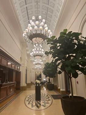 Grand crystal chandeliers and soaring architectural columns in a Miami luxury hotel lobby