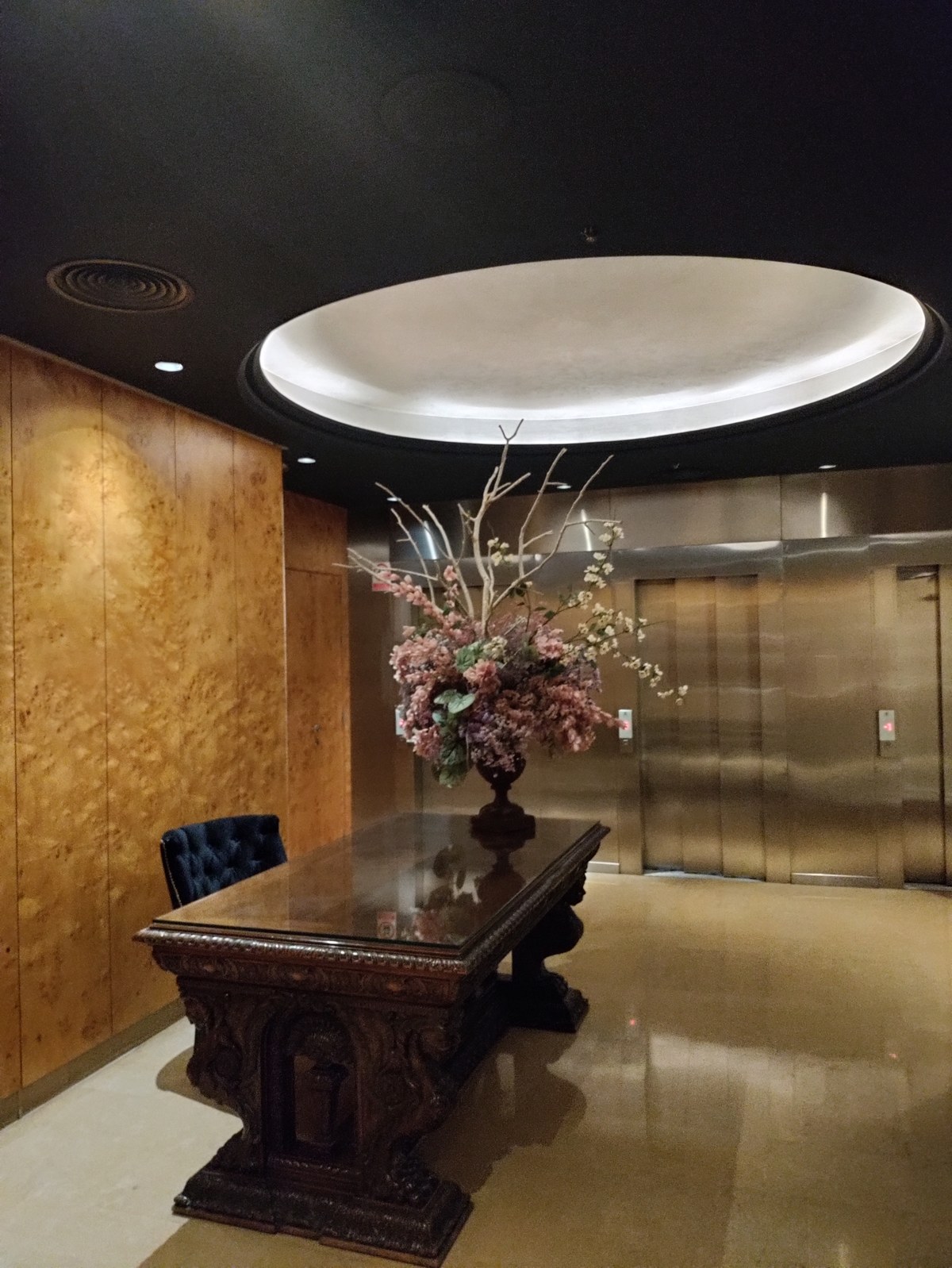 Lobby elevator corridor with antique carved desk at Hotel Claris Barcelona