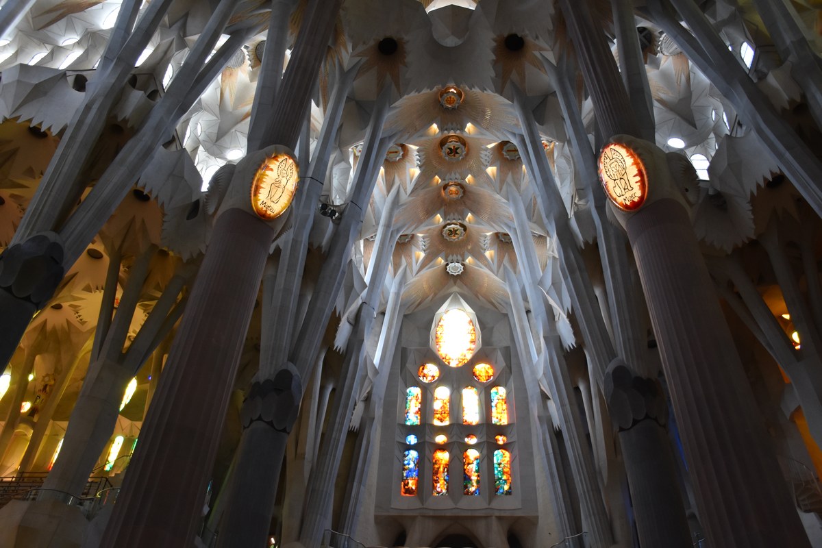 Interior nave stained glass windows and stone columns of Sagrada Familia