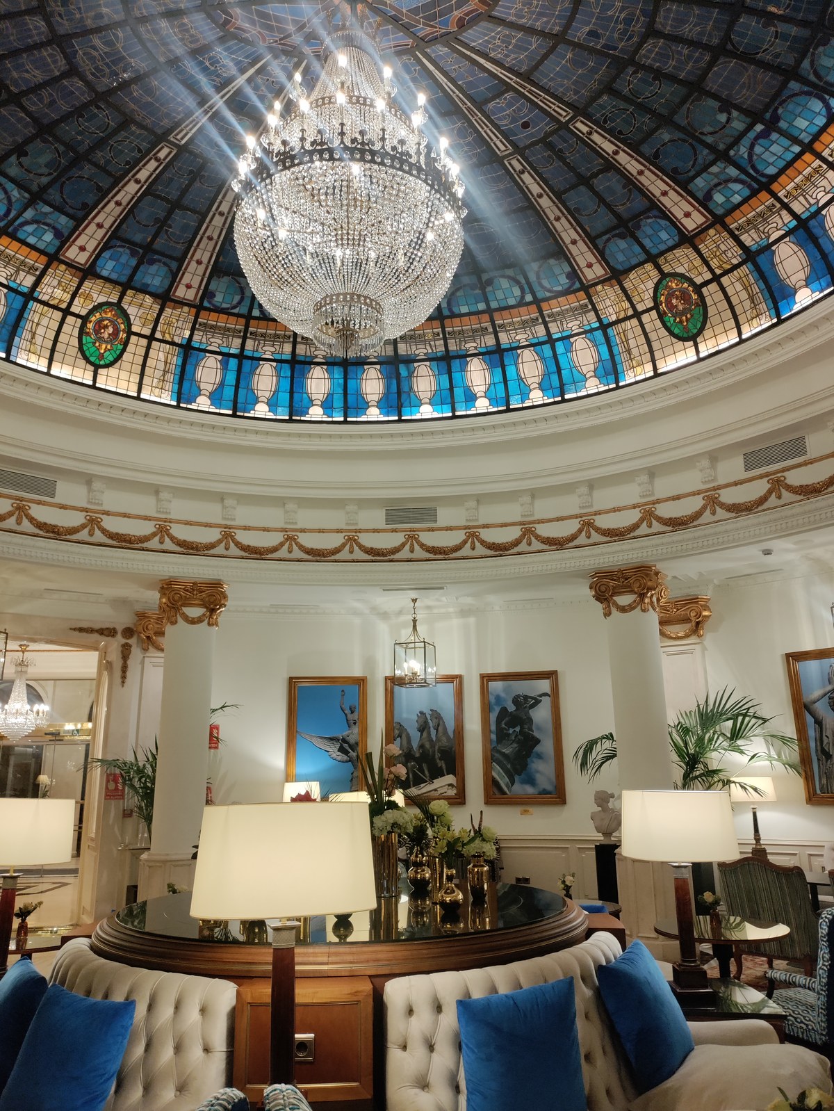 Stained-glass rotunda dome and crystal chandelier in the lobby of Gran Melia Hotel Fenix