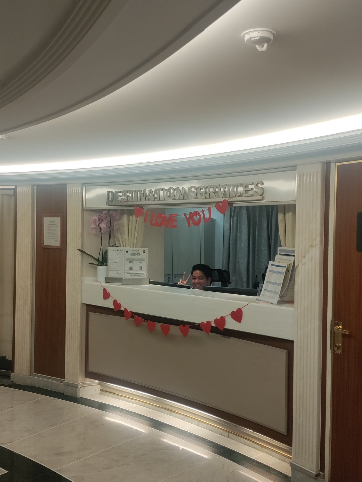 Windstar Cruises Star Legend Destination Services desk with Valentines Day garlands