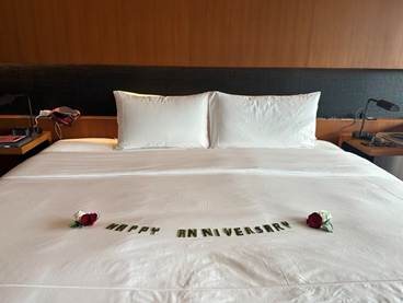 Banana leaf anniversary greeting and flower petals in luxury suite