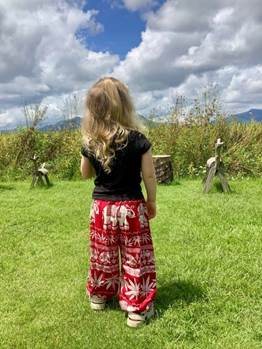 Feeding bananas to rescued elephants wearing Karen tribe clothing