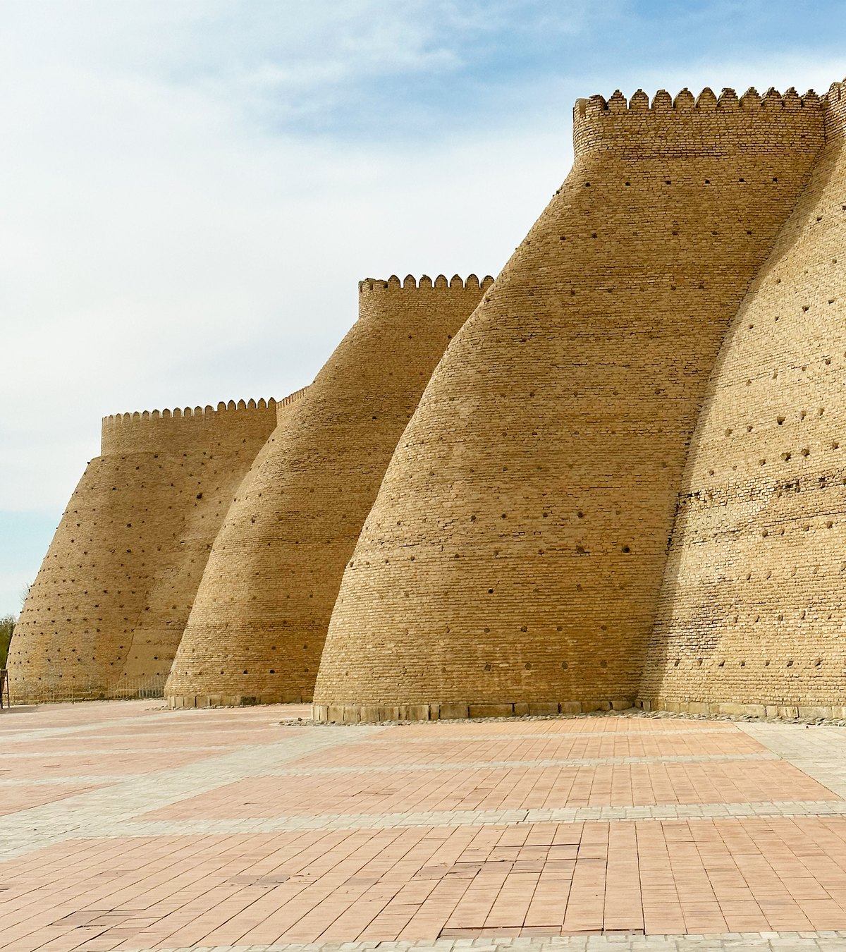Massive sloping mudbrick walls of the Ark Fortress in Bukhara