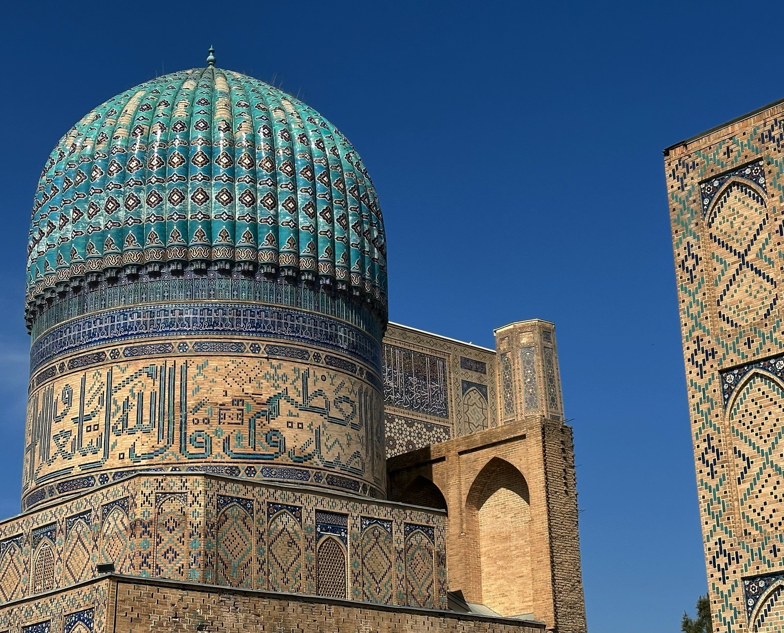 Registan Square illuminated in Samarkand Uzbekistan under sunset skies