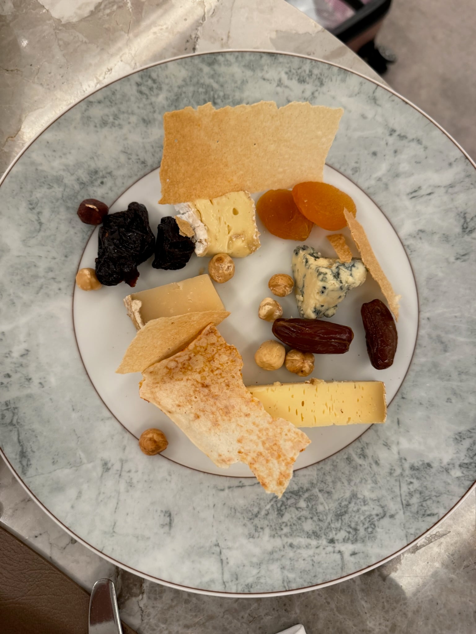 Artisanal European cheese board with fruits and honeycomb