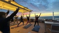 Morning yoga and stretch class on the observation deck of National Geographic Venture