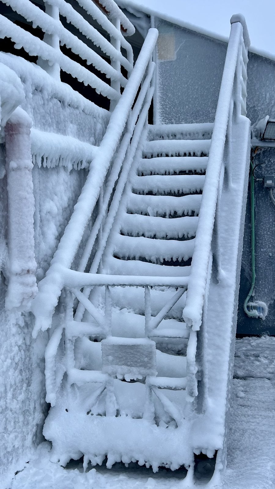 Exterior stairs of Le Commandant Charcot encrusted in thick sea-spray rime ice