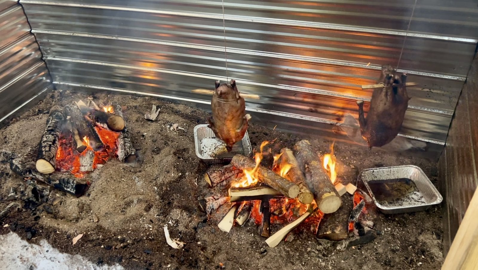Wild geese roasting over open flame hearth during Innu feast at Sept-Iles