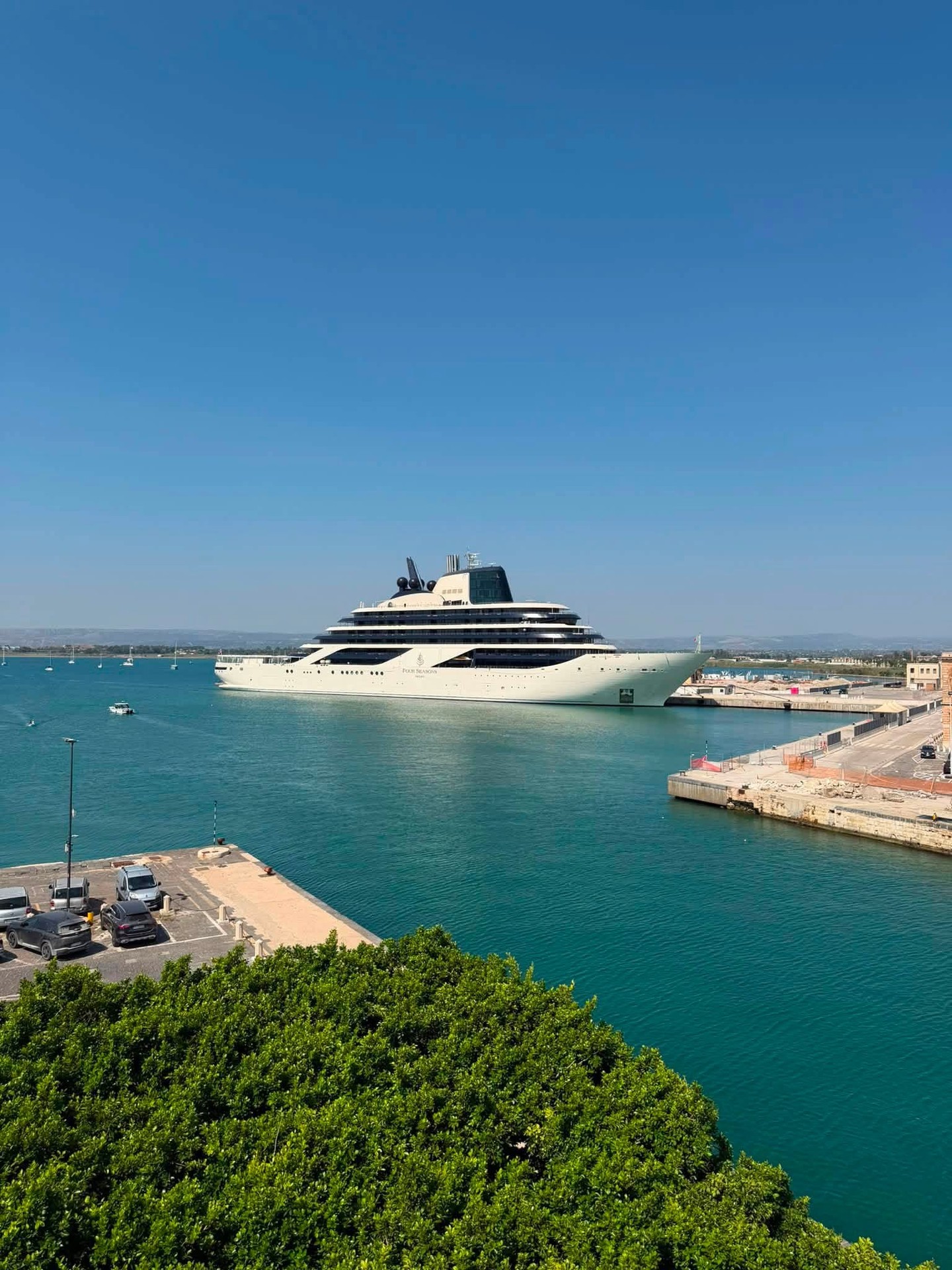 Four Seasons I anchored in an idyllic turquoise Mediterranean bay surrounded by pine-covered hills