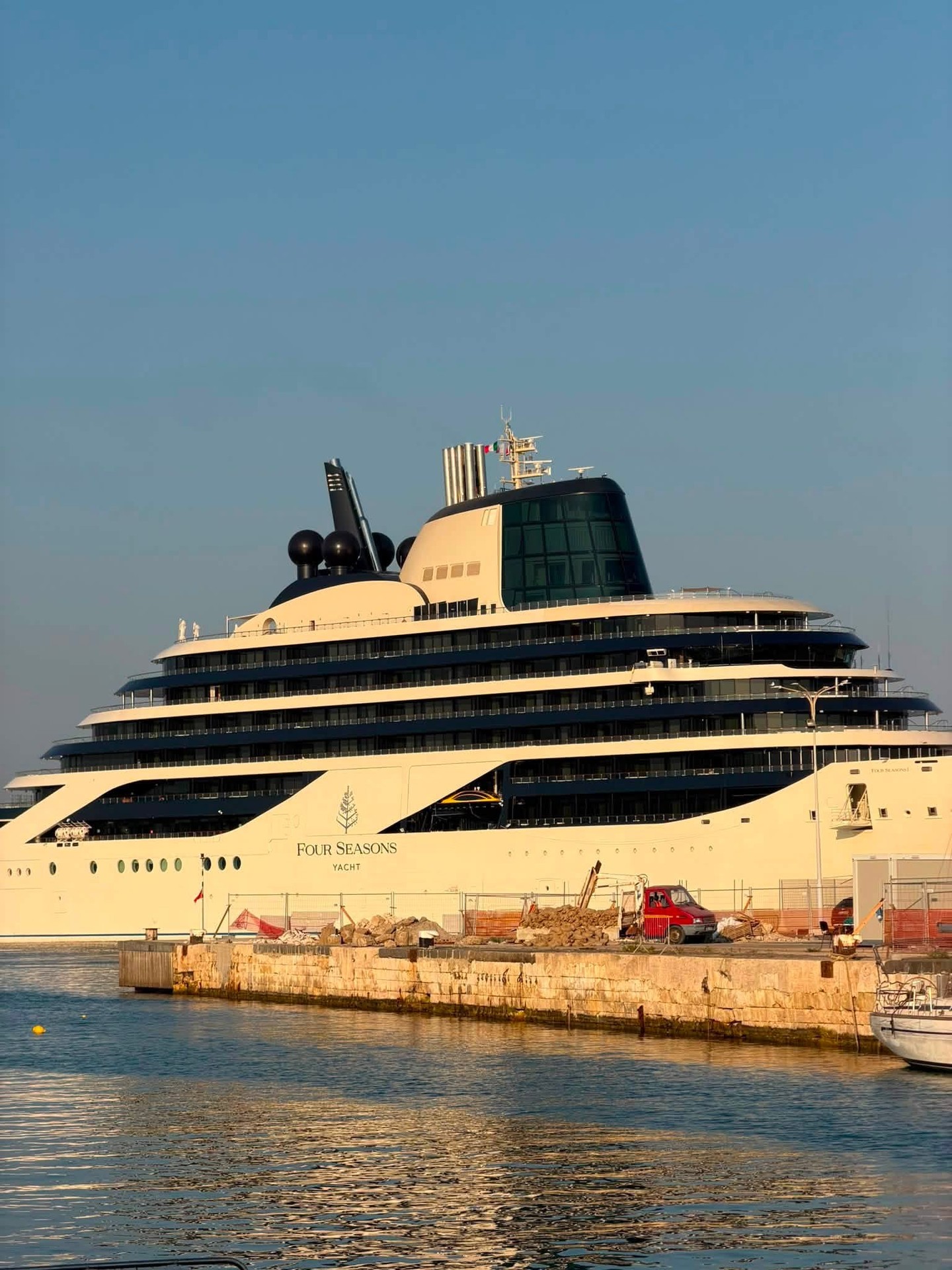Sleek bow and hull exterior profile of Four Seasons I superyacht docked in port