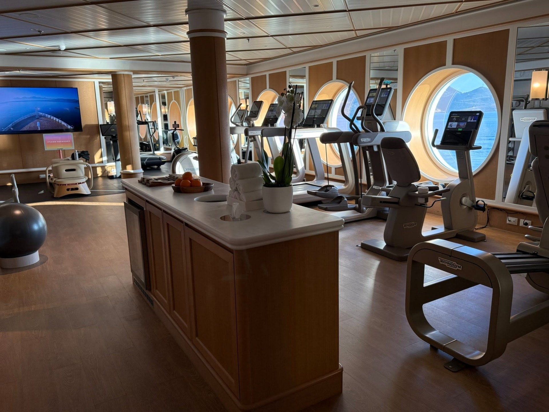 State of the art fitness center with cardio equipment and ocean view on Four Seasons Yachts
