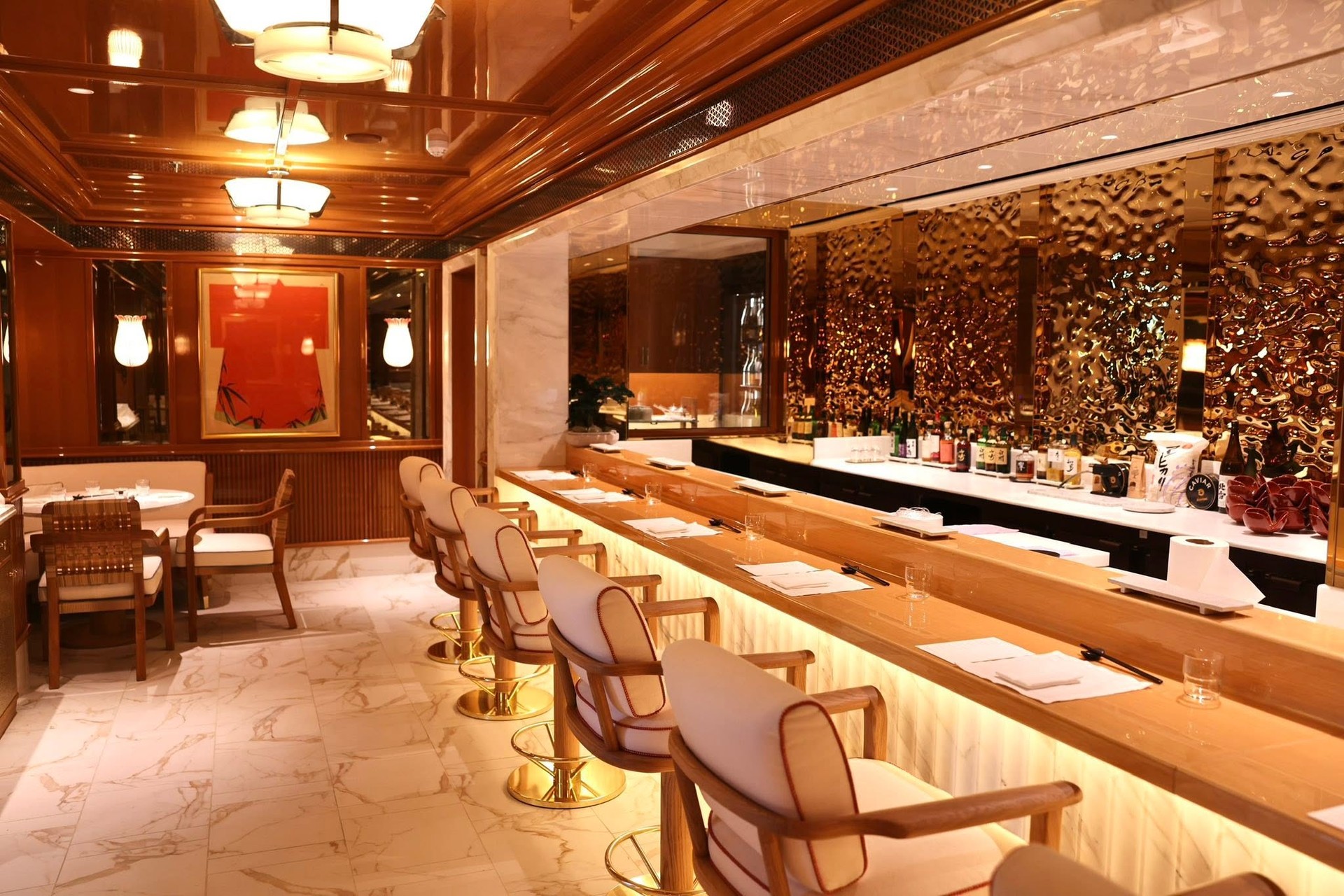 Glamorous cocktail bar with amber backlighting and luxury seating on Four Seasons Yachts