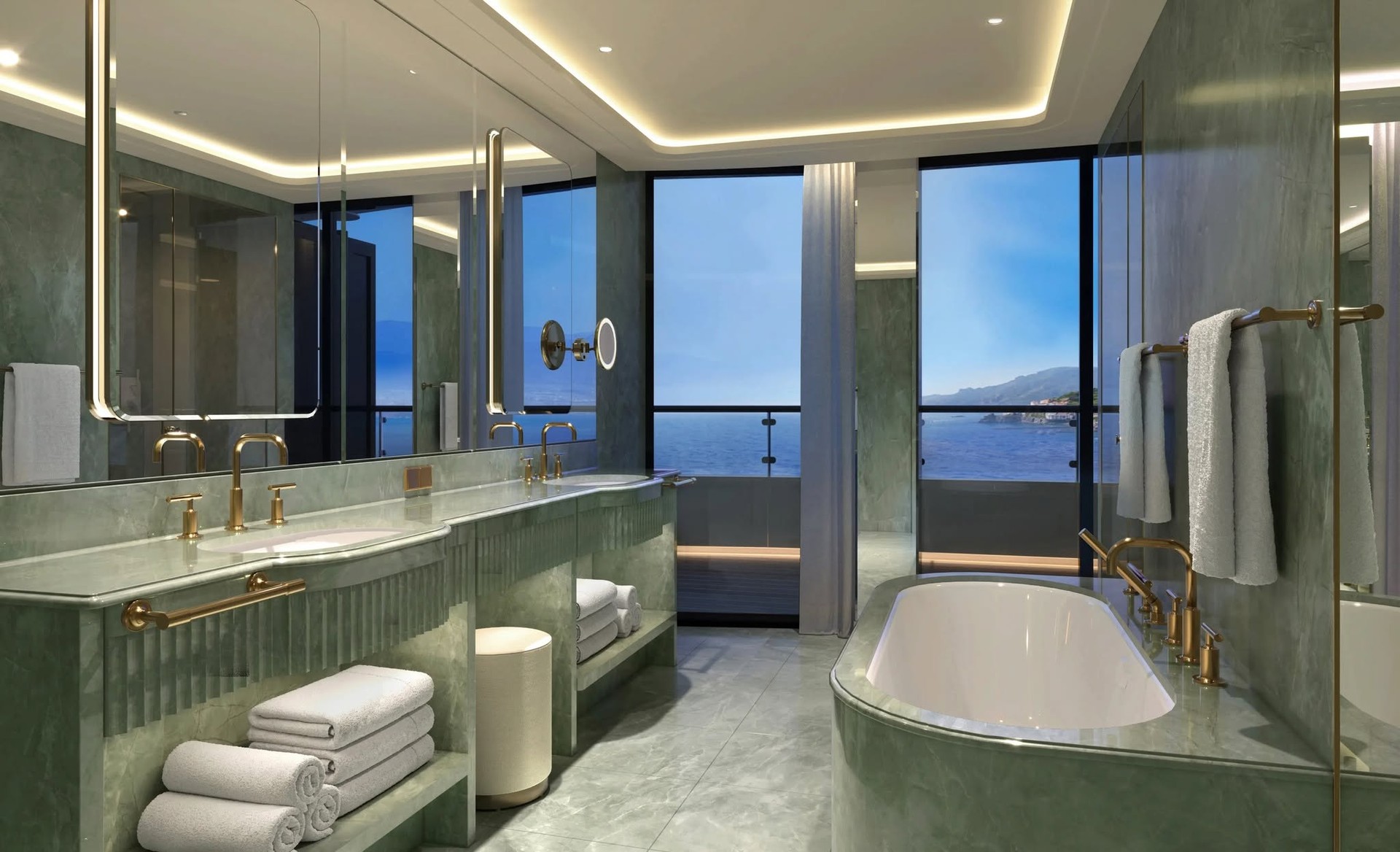 Spacious marble master bathroom with freestanding soaking tub overlooking the sea on Four Seasons Yachts