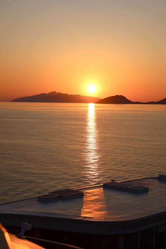 Golden sunset over calm Mediterranean seas viewed from Four Seasons Yachts private terrace