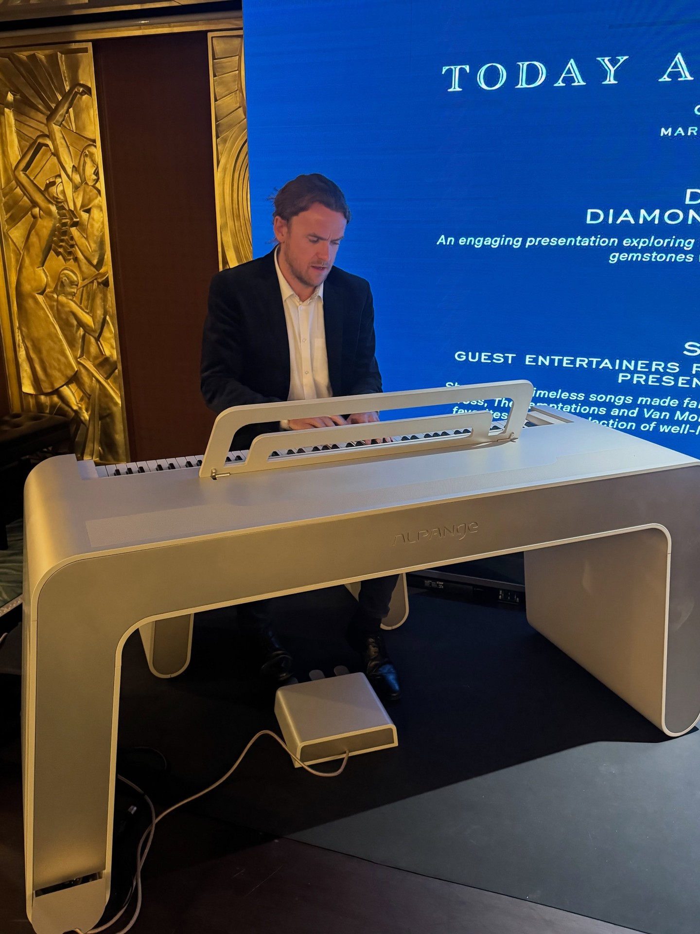 Live pianist performing on white grand piano in Four Seasons Yachts lounge