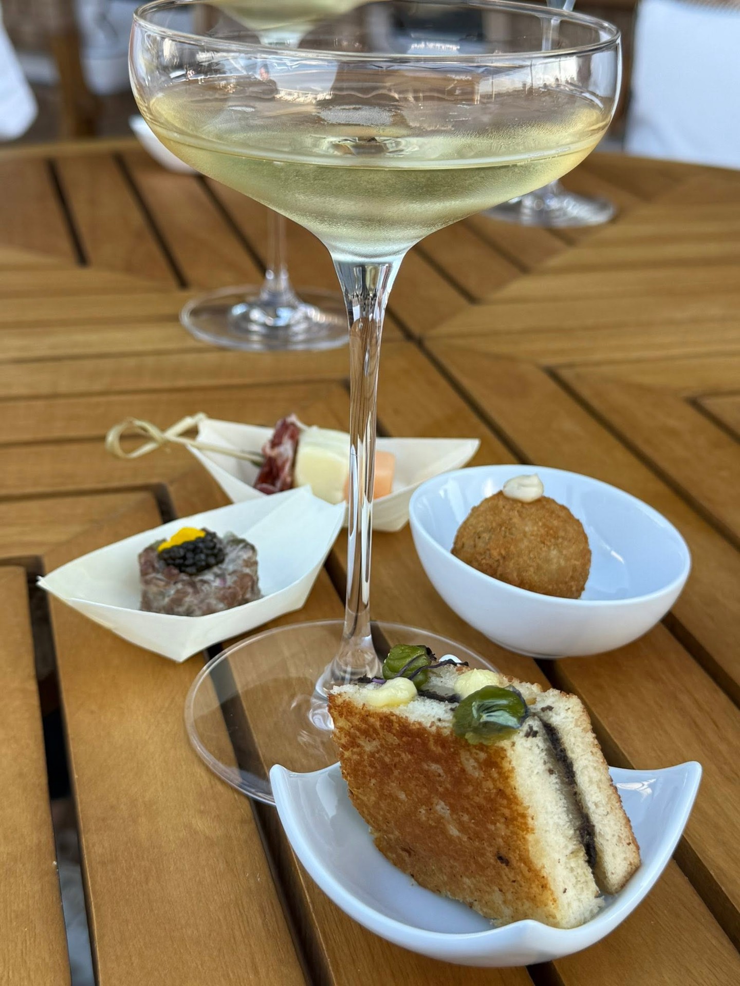 Alfresco lunch with chilled wine and gourmet sandwiches on private terrace aboard Four Seasons Yachts
