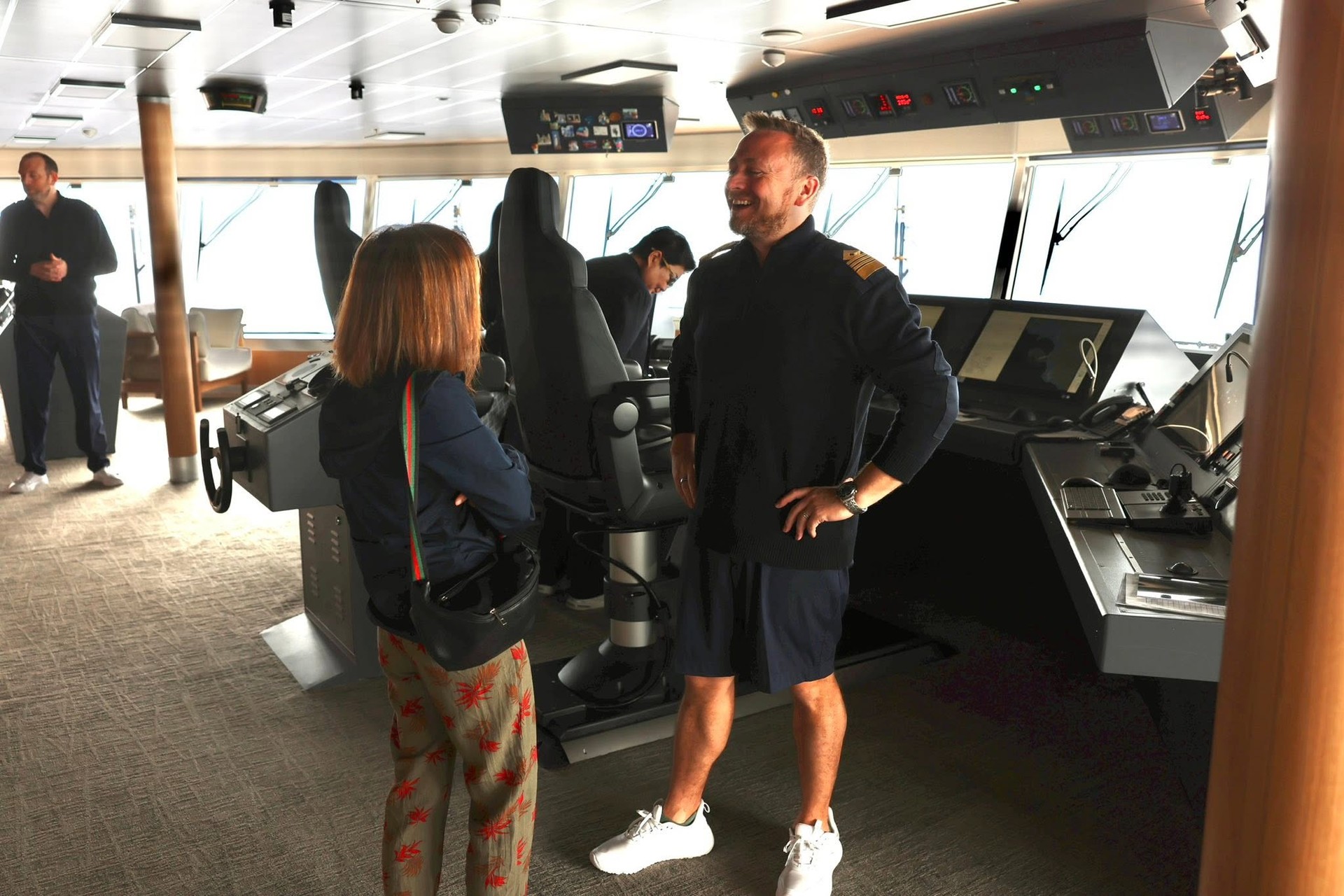 Guests visiting the high-tech navigation bridge on Four Seasons Yachts