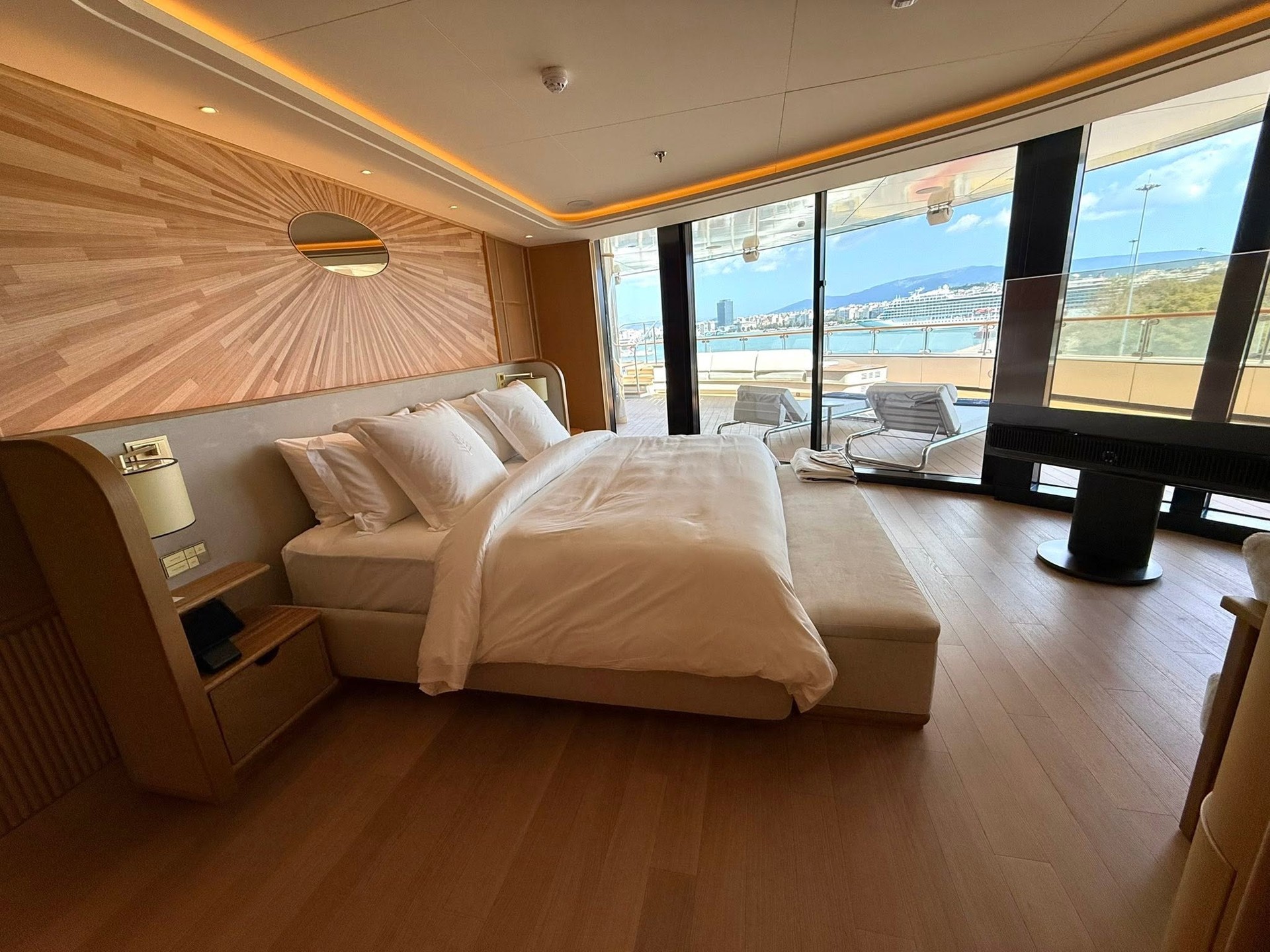 Saint Tropez Suite bedroom illuminated with natural morning light on Four Seasons Yachts