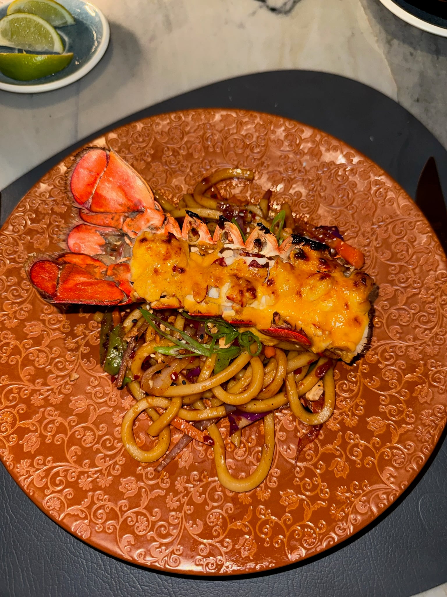 Succulent grilled lobster tail served over handmade pasta on Ilma