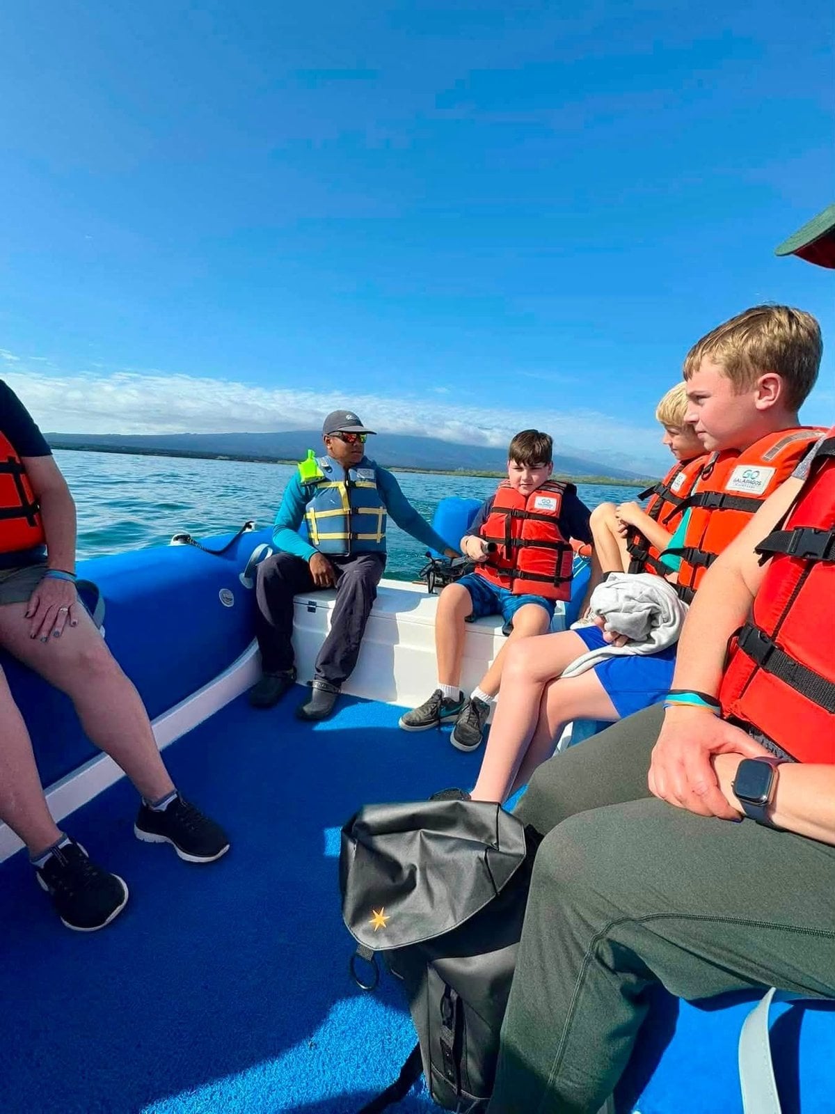 Adventures by Disney guests riding a panga Zodiac boat out for a deep water snorkel in the Galapagos