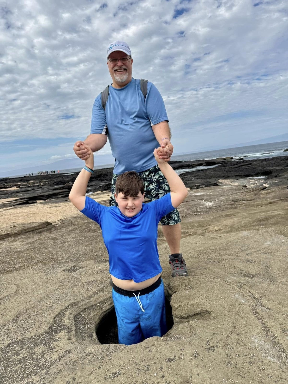 Having fun with forced-perspective family photography on the volcanic beaches of the Galapagos